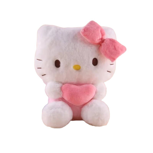 My Store plush Hello Kitty toy holding a pink heart with a matching pink bow, sitting on a desk with books.